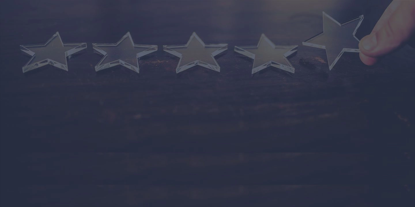 4 small glass stars on a table with a fifth added.