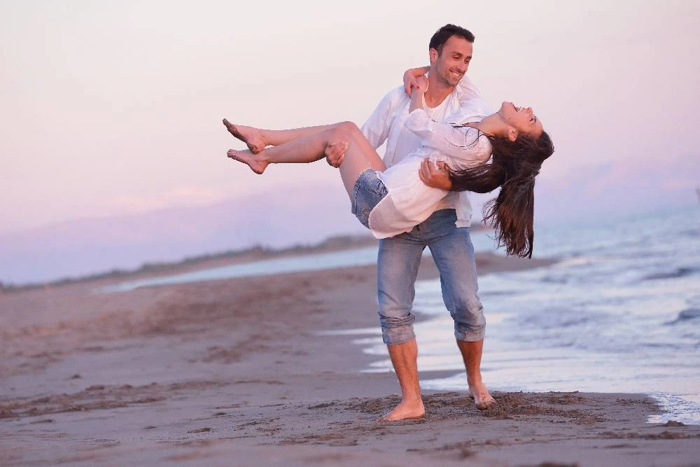 Χαρούμενο ζευγάρι απολαμβάνει την παραλία σε μήνα του μέλιτος