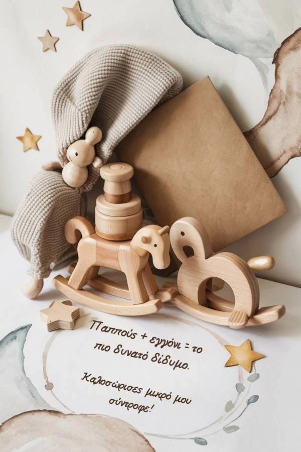 Ευχετήρια κάρτα για νεογέννητο από τον παππού, με ξύλινα παιχνίδια μωρού, ένα πλεκτό σκουφάκι και διακοσμητικά αστεράκια. Το κείμενο γράφει: Παππούς + εγγόνι = το πιο δυνατό δίδυμο. Καλωσόρισες μικρό μου σύντροφε!