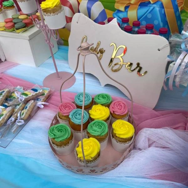 Γλυκίσματα σε βάπτιση με θέμα Candyland με πολύχρωμα cupcakes και μακαρόν