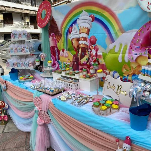Τραπέζι βάπτισης με ζαχαρωτά, λολίτες και πολύχρωμα υφάσματα σε στυλ Candyland