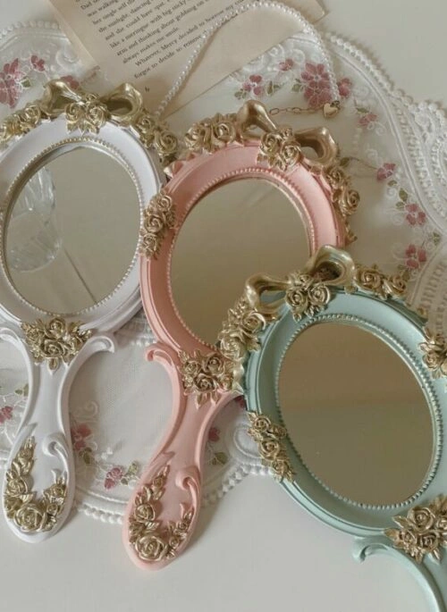 Oval-Shaped Hand Mirror with Gold Embellishment